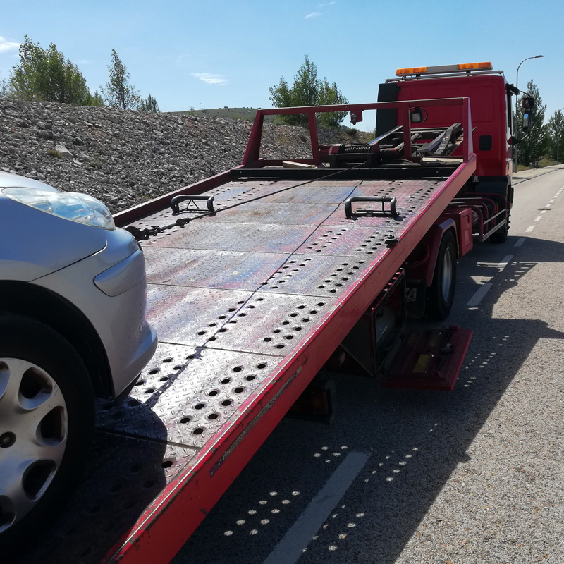 car being loaded on flatbed tow truck